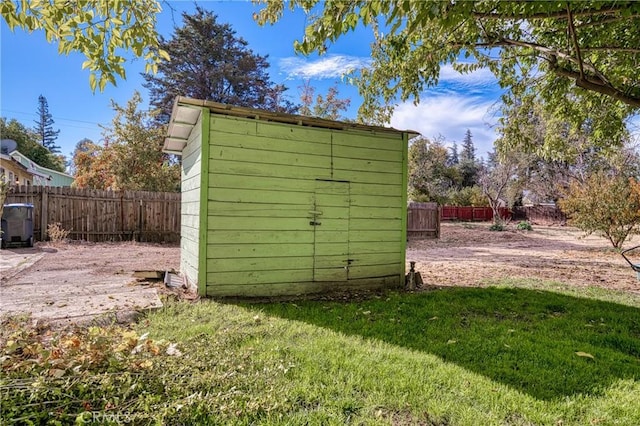 view of outbuilding featuring a lawn