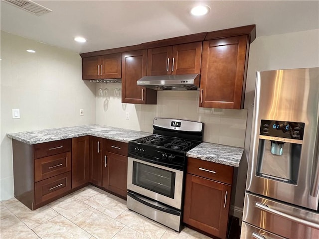 kitchen with backsplash, light stone counters, and stainless steel appliances