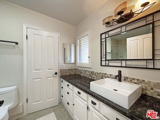 bathroom featuring decorative backsplash, vanity, toilet, and tile patterned flooring