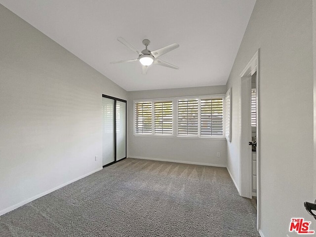 unfurnished bedroom featuring carpet floors, ceiling fan, and lofted ceiling