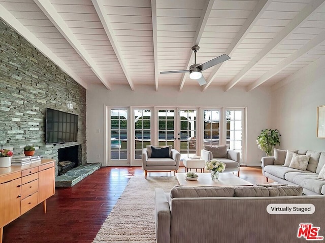 living room featuring ceiling fan, french doors, dark wood-type flooring, beamed ceiling, and a fireplace