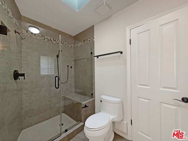 bathroom with toilet and walk in shower