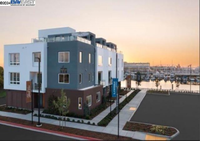 outdoor building at dusk featuring a water view