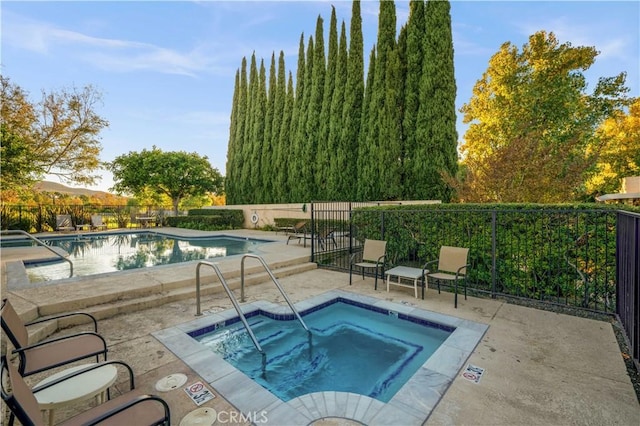 view of pool featuring a patio and a community hot tub