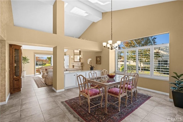 dining space featuring high vaulted ceiling, light tile patterned floors, and a notable chandelier