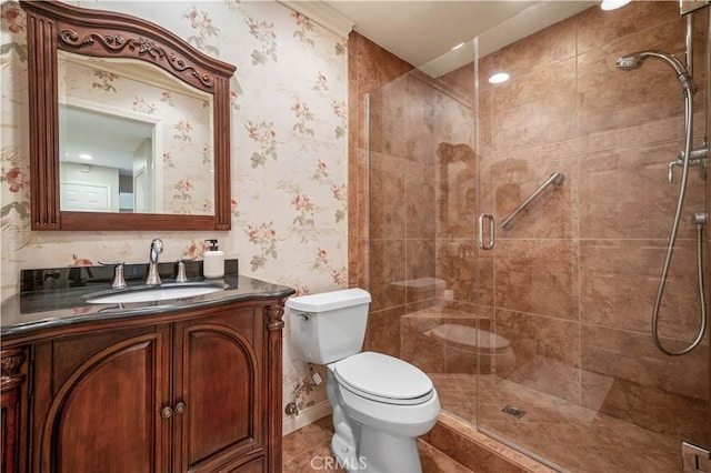 bathroom with vanity, toilet, and a shower with door