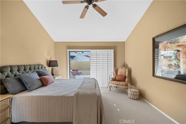 carpeted bedroom with ceiling fan and vaulted ceiling