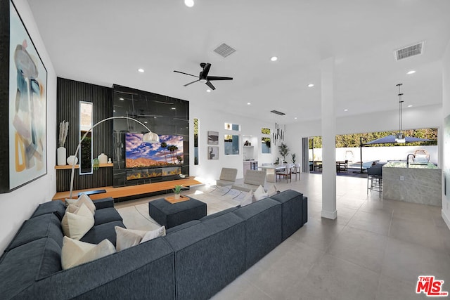 living room featuring ceiling fan and sink