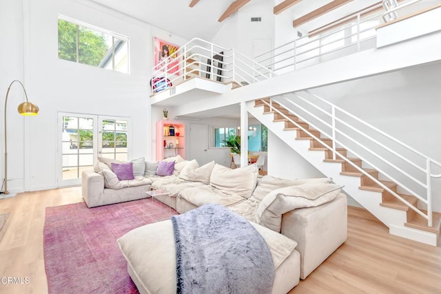 living room featuring plenty of natural light, high vaulted ceiling, and hardwood / wood-style floors