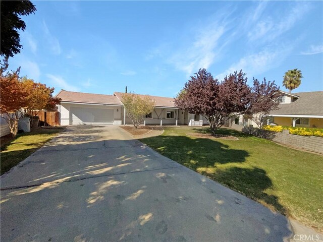 view of front facade with a front yard and a garage