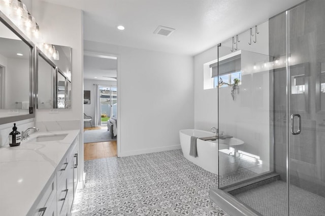 bathroom featuring independent shower and bath and vanity