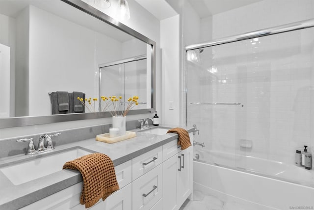 bathroom with vanity and bath / shower combo with glass door