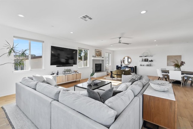 living room with ceiling fan and light hardwood / wood-style floors