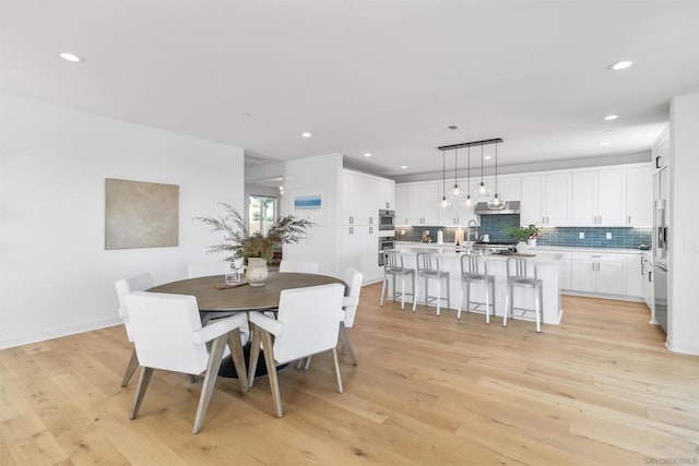 dining area featuring light wood-type flooring