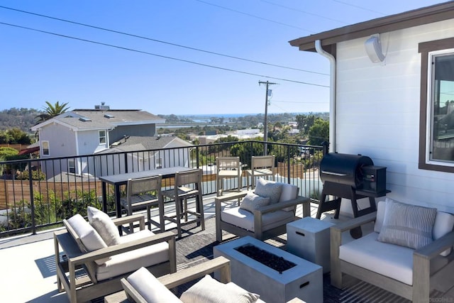 view of patio / terrace featuring area for grilling and an outdoor living space with a fire pit