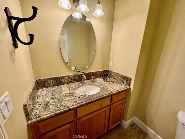 bathroom with tile patterned flooring, vanity, and toilet