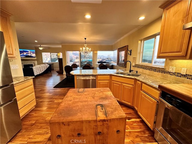 kitchen with sink, a kitchen island, wooden counters, and wood-type flooring