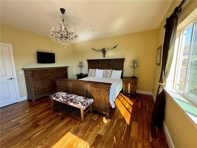 bedroom with dark wood-type flooring and a notable chandelier