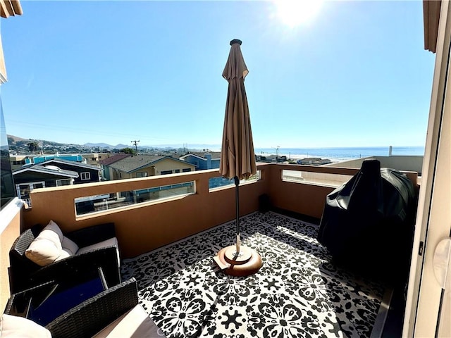 balcony featuring a water view