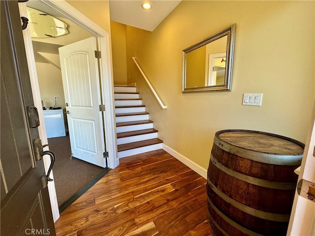 stairway with hardwood / wood-style flooring