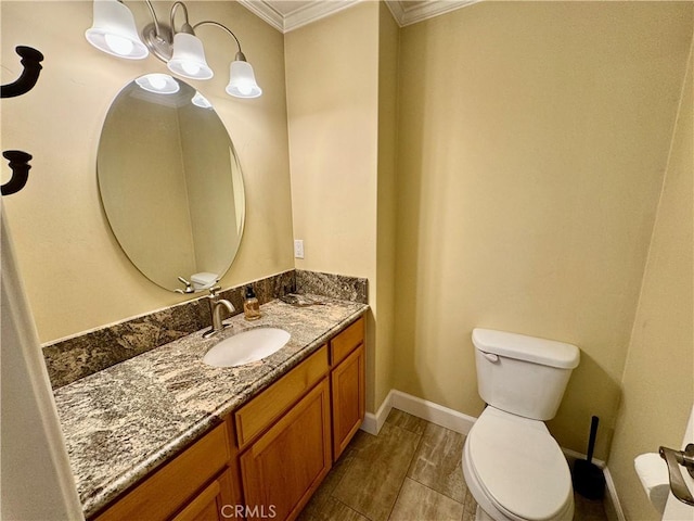 bathroom with crown molding, hardwood / wood-style floors, vanity, and toilet