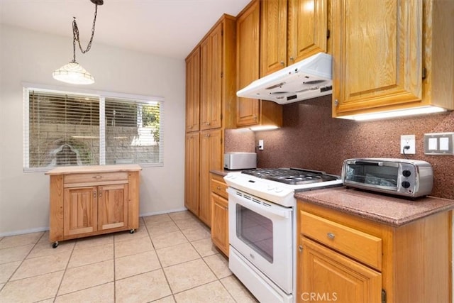 kitchen with decorative backsplash, pendant lighting, white range, and light tile patterned floors