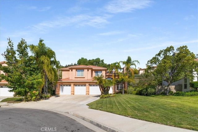 mediterranean / spanish-style home with a front lawn and a garage