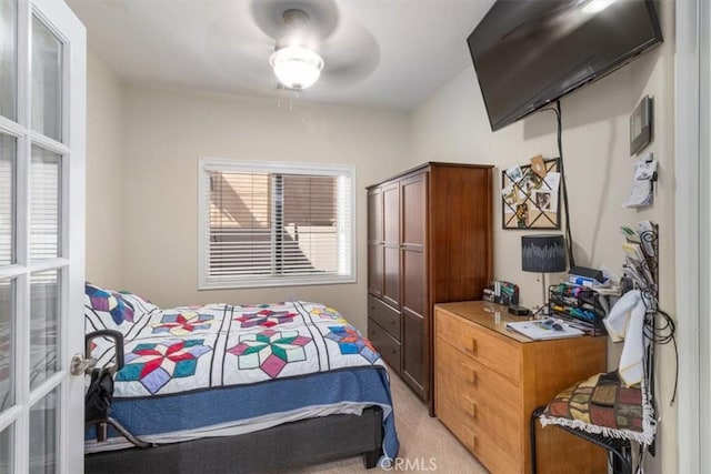 bedroom with ceiling fan and light colored carpet