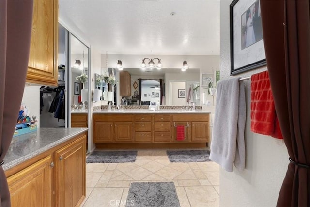 bathroom featuring tile patterned flooring and vanity