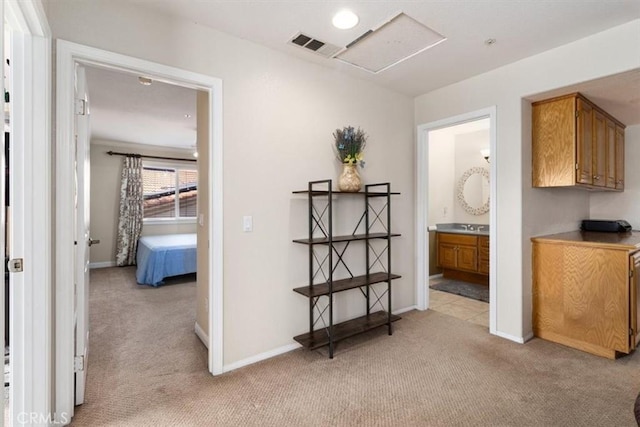 hallway with light colored carpet