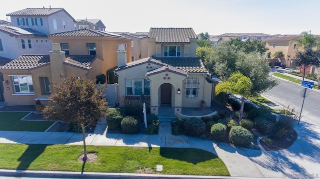 mediterranean / spanish home featuring a front yard