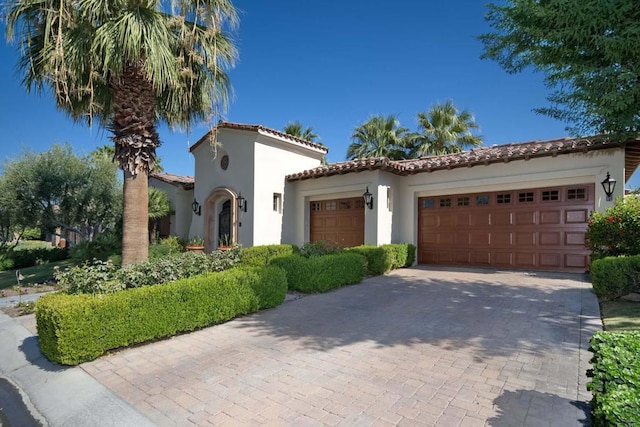 mediterranean / spanish-style home with a garage