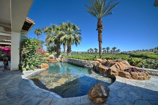 view of swimming pool featuring a patio area and pool water feature