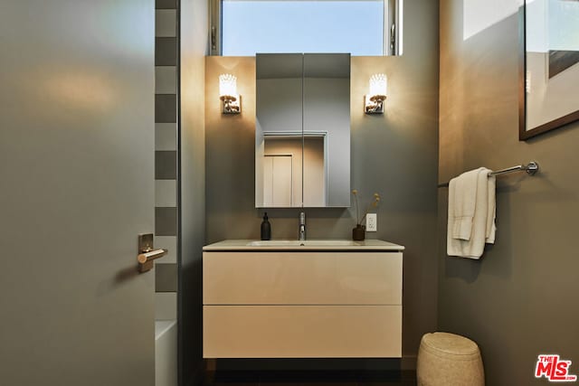 bathroom featuring a tub to relax in and vanity