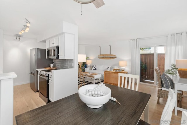 dining area featuring ceiling fan and light hardwood / wood-style flooring