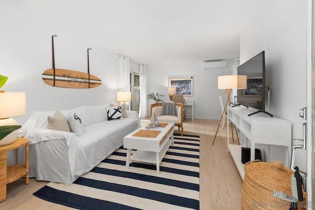 living room featuring light hardwood / wood-style flooring and a wall mounted air conditioner