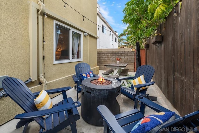 view of patio with a fire pit