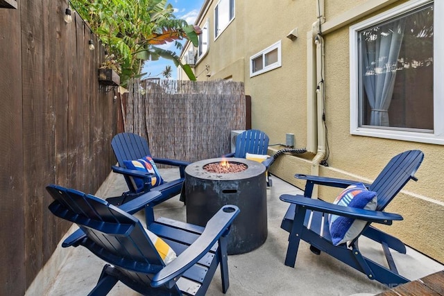 view of patio / terrace featuring an outdoor fire pit