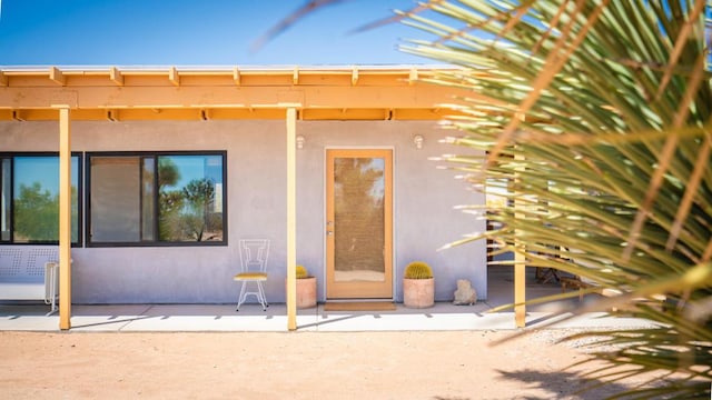 doorway to property featuring a patio