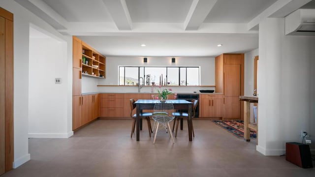 dining space with beamed ceiling and sink