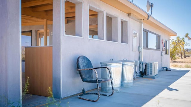 view of property exterior featuring a patio area and central AC unit