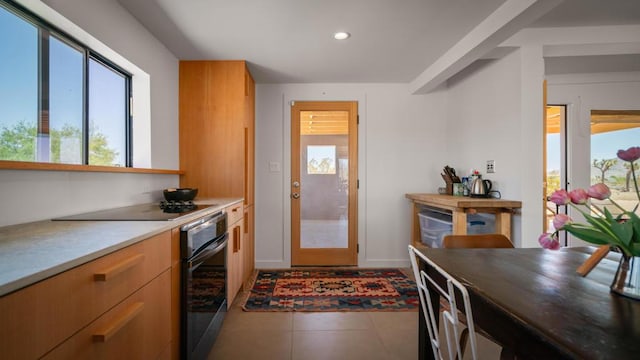 kitchen featuring oven and dark tile patterned flooring