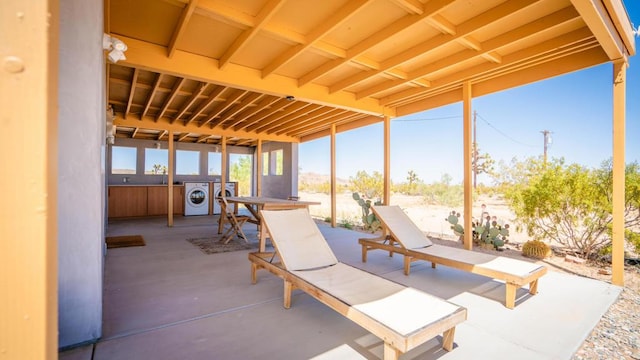 view of patio featuring independent washer and dryer