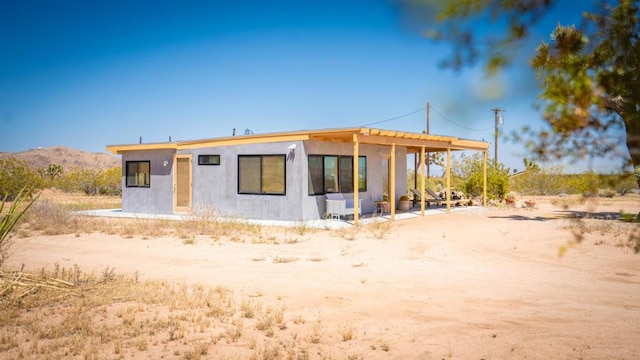 back of property with a mountain view