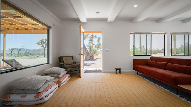 living room featuring beamed ceiling