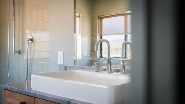 bathroom with sink and tile walls