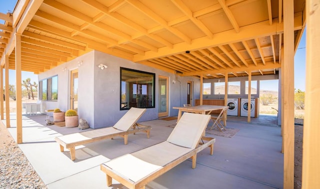 view of patio with separate washer and dryer