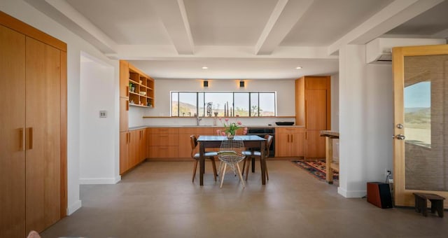 kitchen featuring beam ceiling and light brown cabinetry