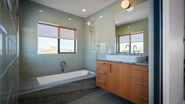 bathroom with tile patterned floors, vanity, and tile walls