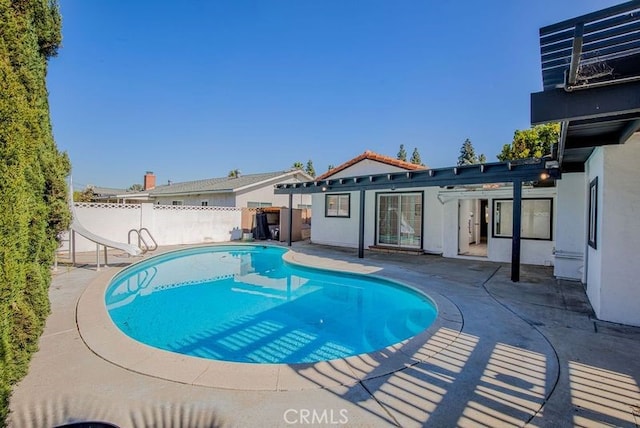 view of swimming pool with a pergola, a patio area, and a water slide